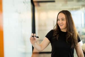 HRT woman writing on white board